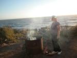 Bonnie roasting a marshmellow at the ocean campsite