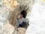 Bonnie hiding in a rock on the beach