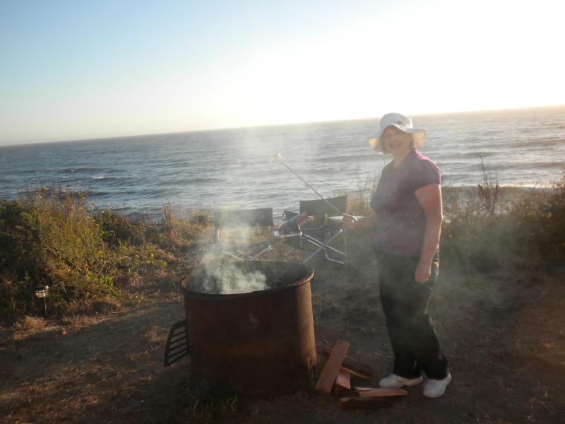 Bonnie roasting a marshmellow at the ocean campsite