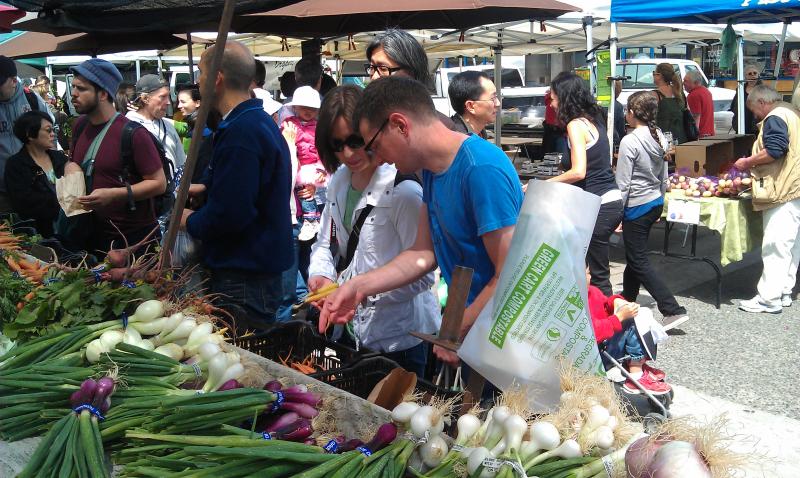 Steve and Emily discussing carrots at Farmers Market